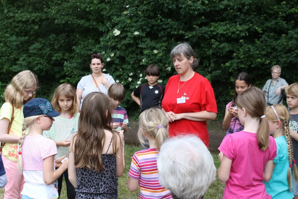 Frau spricht zu Kindern